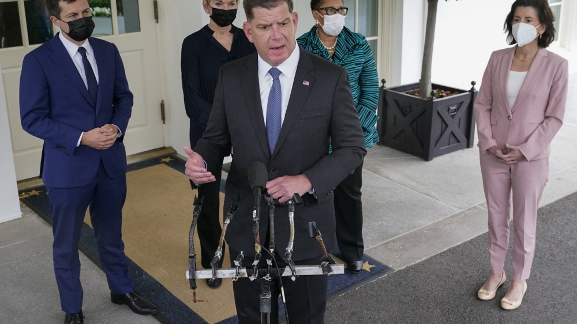 Labor Secretary Marty Walsh, center, speaks with reporters outside the West Wing of the White House after a meeting with President Joe Biden and Vice President Kamala Harris, Friday, May 7, 2021, in Washington. Standing behind Walsh are Transportation Secretary Pete Buttigieg, from left, Energy Secretary Jennifer Granholm, Secretary of Housing and Urban Development Marcia Fudge and Commerce Secretary Gina Raimondo. (AP Photo/Patrick Semansky)
