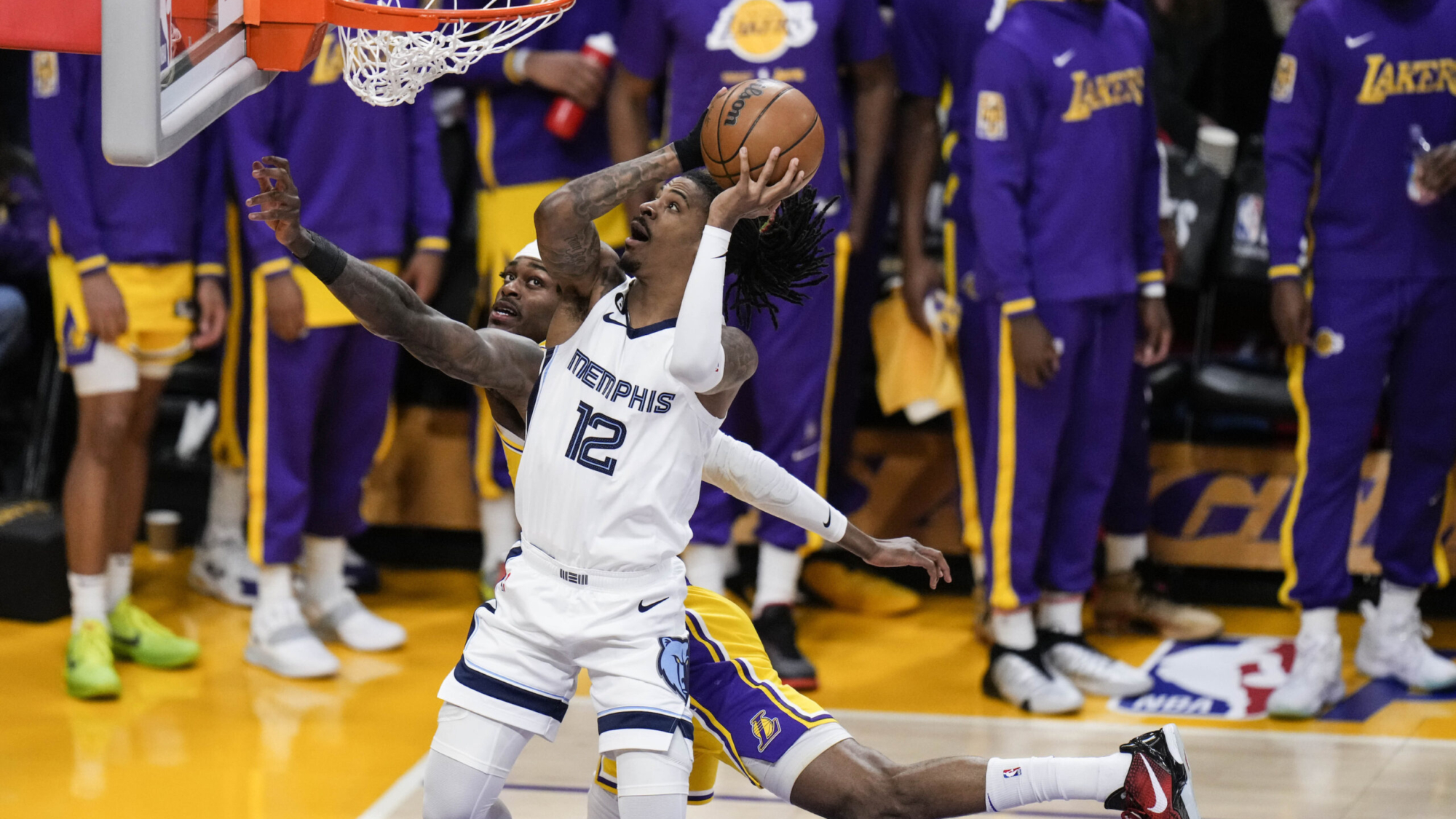 Memphis Grizzlies' Ja Morant (12) drives to the basket against Los Angeles Lakers' Jarred Vanderbilt during the first half in Game 6 of a first-round NBA basketball playoff series Friday, April 28, 2023, in Los Angeles. (AP Photo/Jae C. Hong)